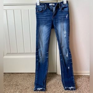 Size 24 KanCan distressed mid-rise skinny jeans.